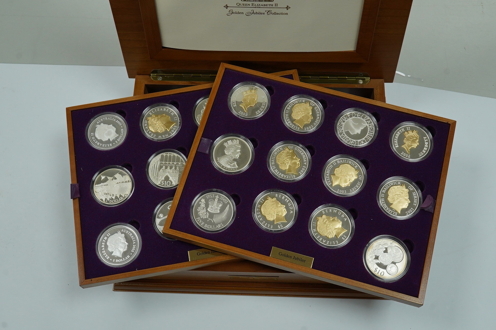 Royal Mint UK QEII Golden Jubilee collection of 24 silver proof coins, 2002, each 28.28g, in wood case fitted with two trays, with individual certificates and album